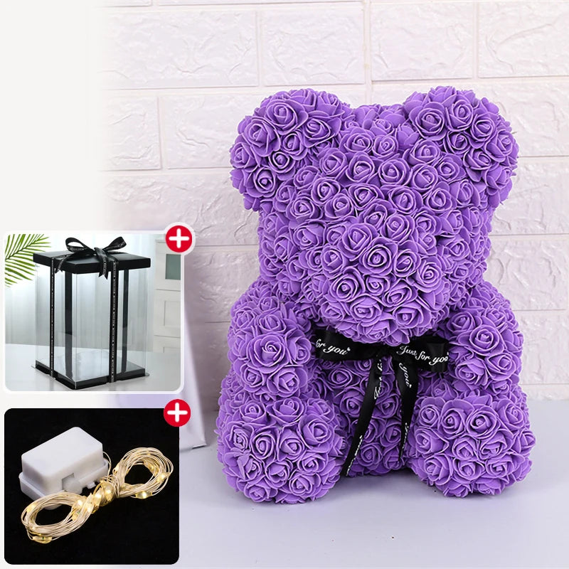 Peluche ours rose violet avec décoration LED et accessoire lumineux séparé.