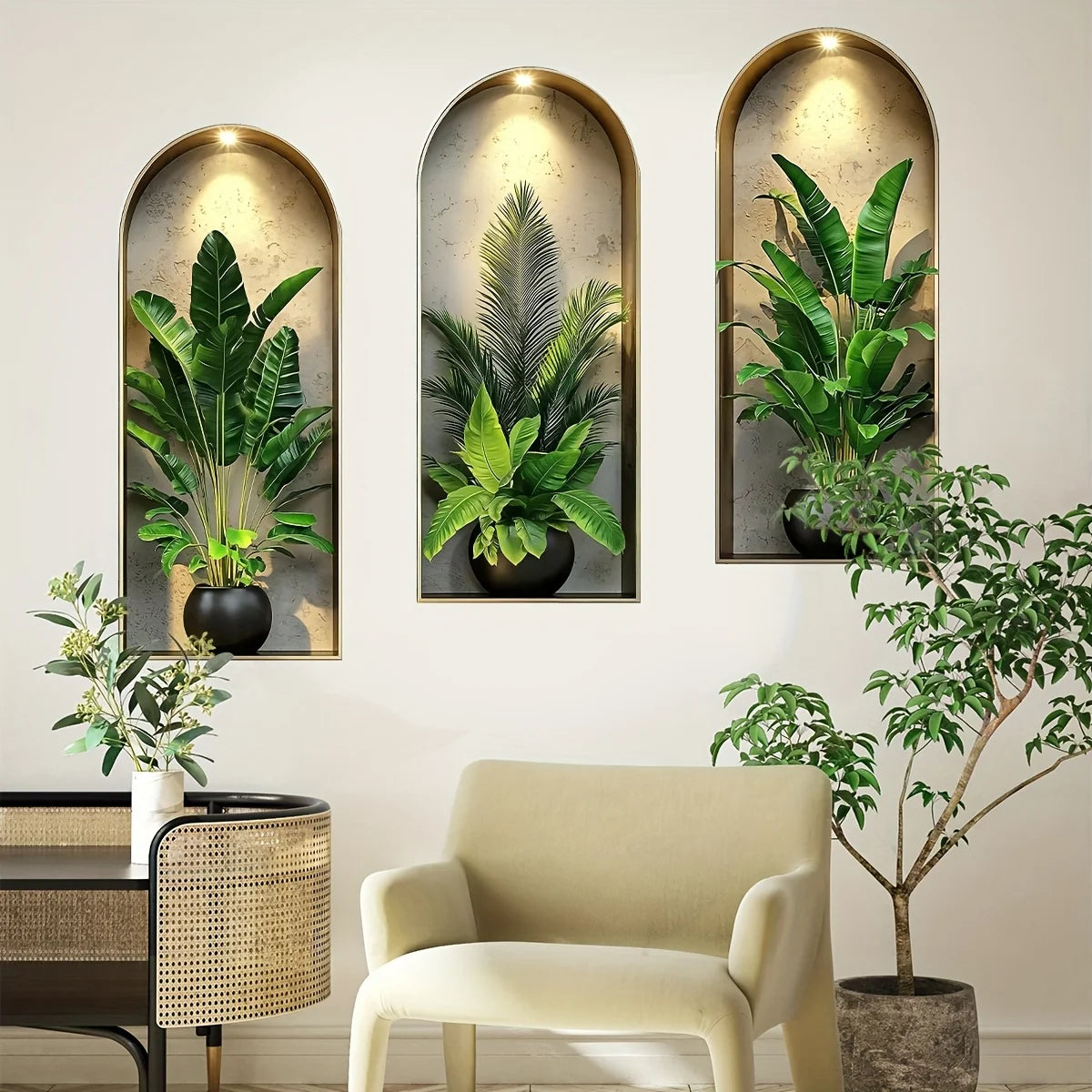 A gallery wall featuring three potted green plants in arched frames on a white wall.