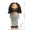 A plush doll depicting Jesus and the Virgin Mary with dark hair and striped clothing.