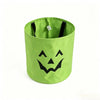 Lime green trick-or-treat bag with a black smiling face design