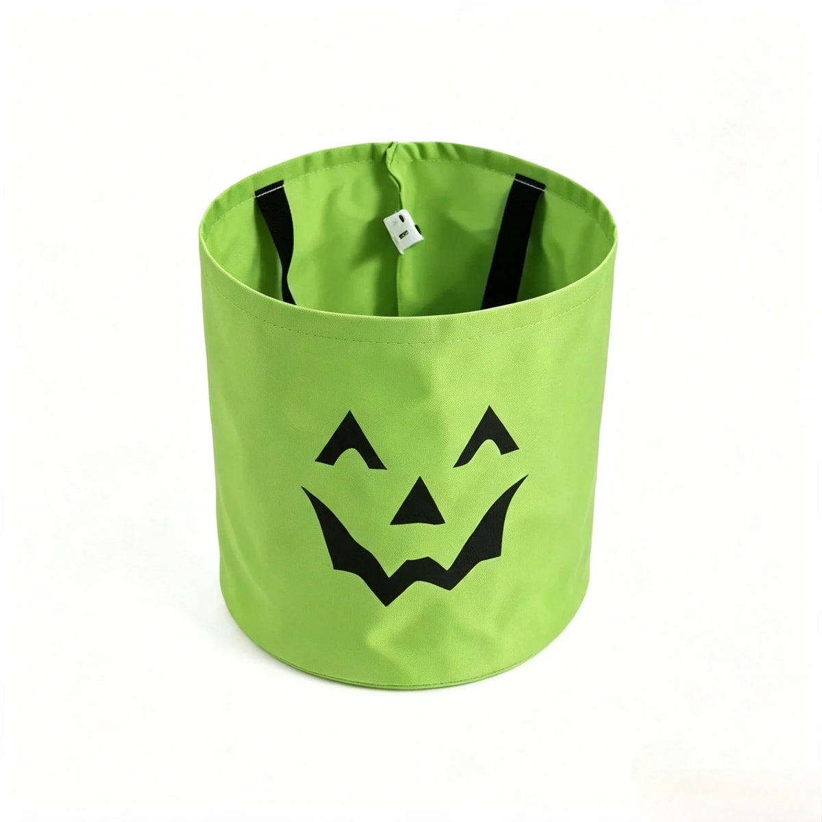 Lime green trick-or-treat bag with a black smiling face design