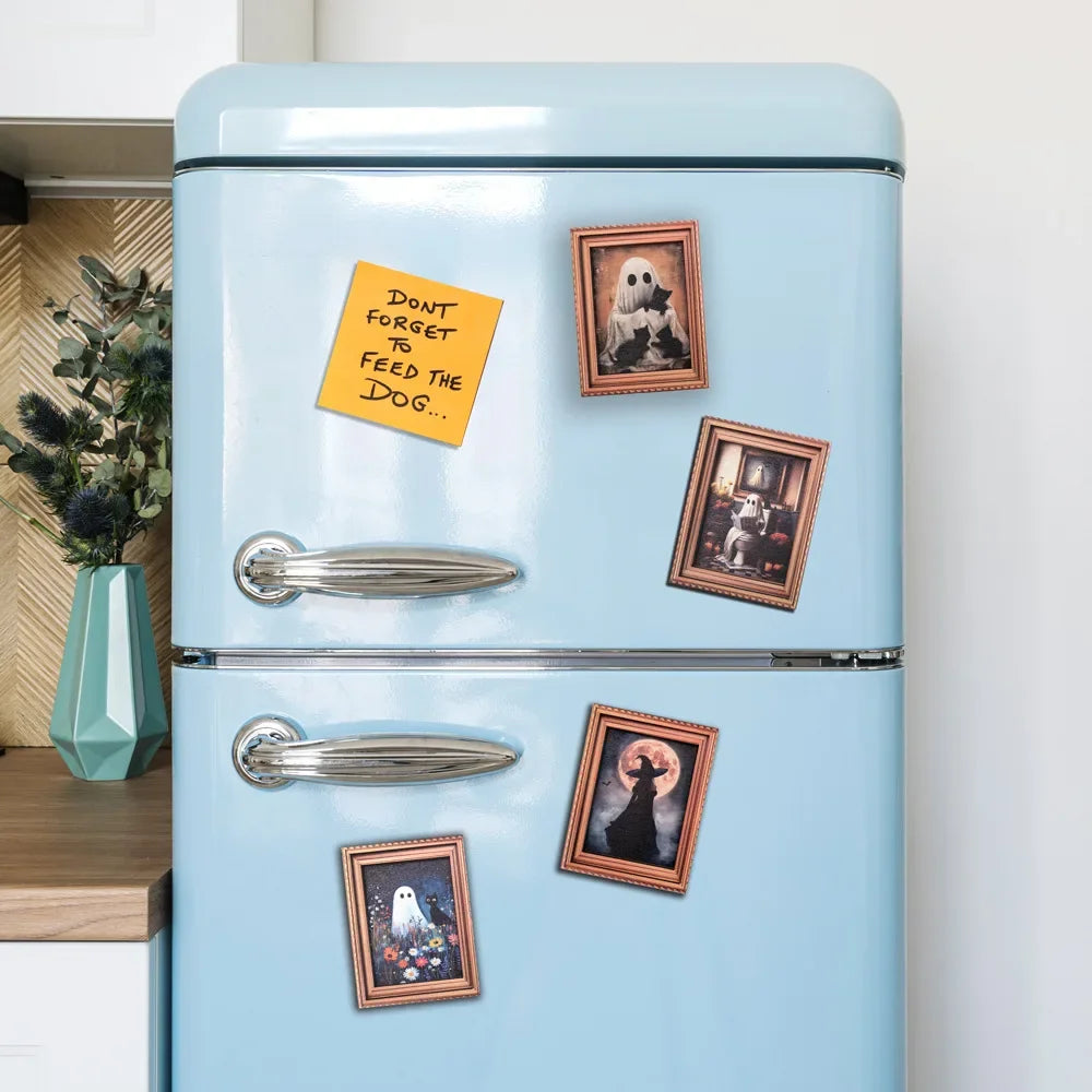A light blue refrigerator decorated with several framed Halloween magnets featuring ghosts and pumpkins.