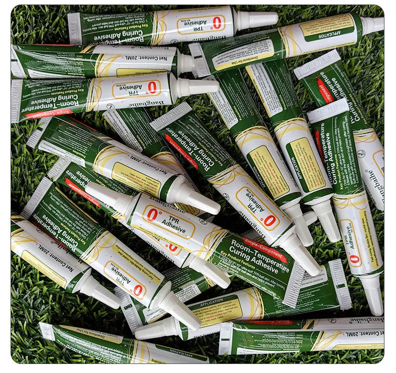 A collection of green and white tubes of Room-Temperature Curing Adhesive for squishy toy repairs