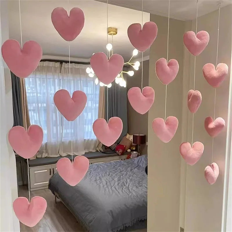 Pink heart-shaped string door curtain with romantic bead design hanging in a bedroom
