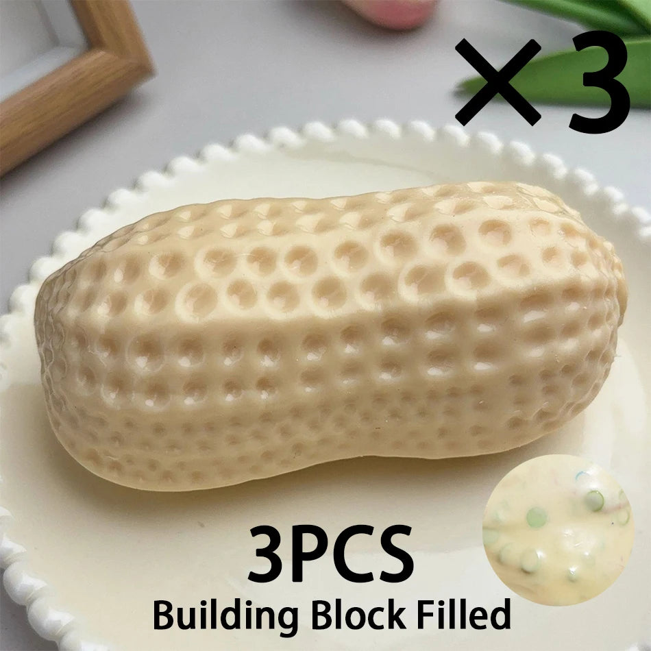 Three peanut-shaped building blocks filled with material for a fidget toy