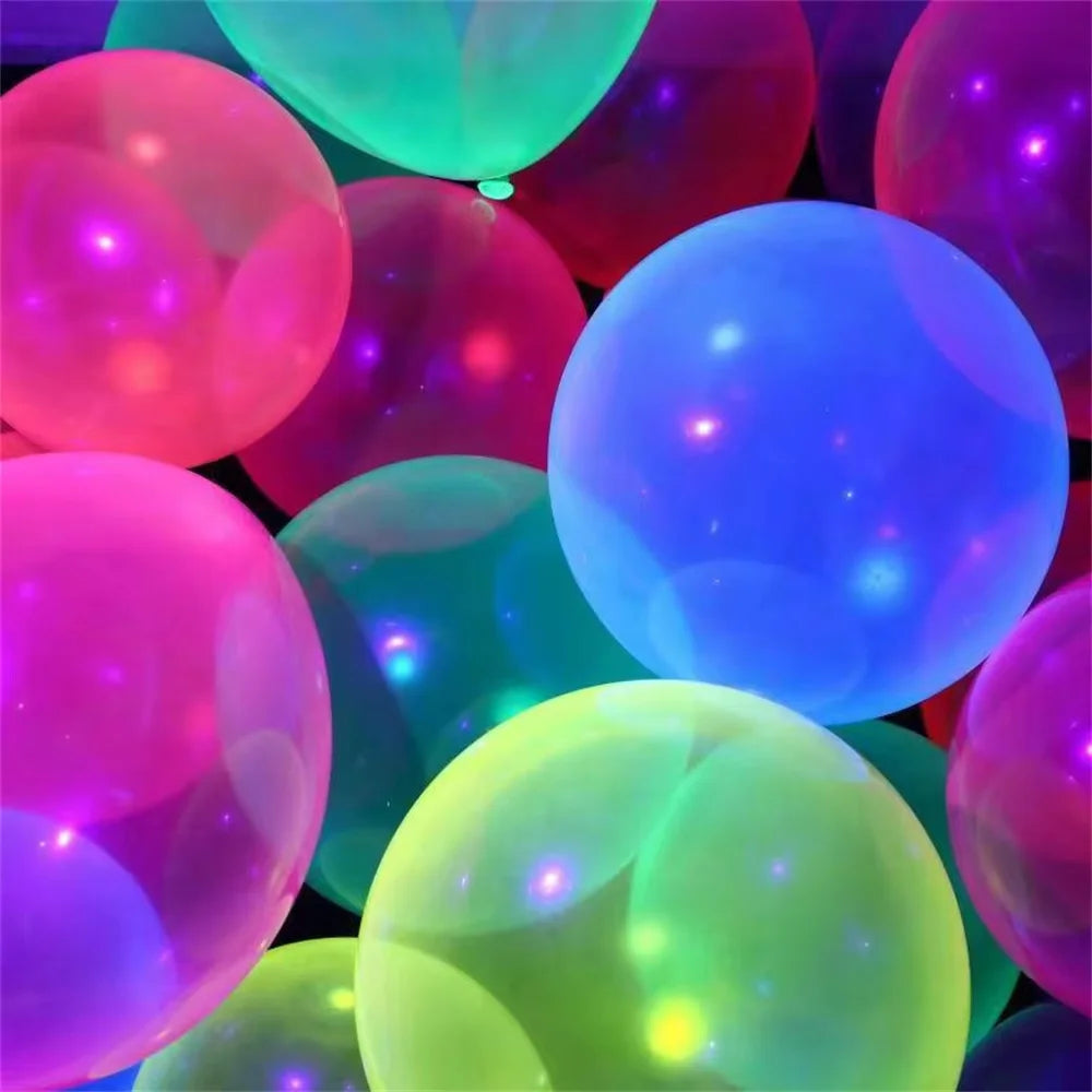 A close-up of glowing neon latex balloons in various vibrant colors like pink, purple, blue, and green.