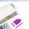 A diamond painting kit showing various colored beads and a pink brush on a white canvas.
