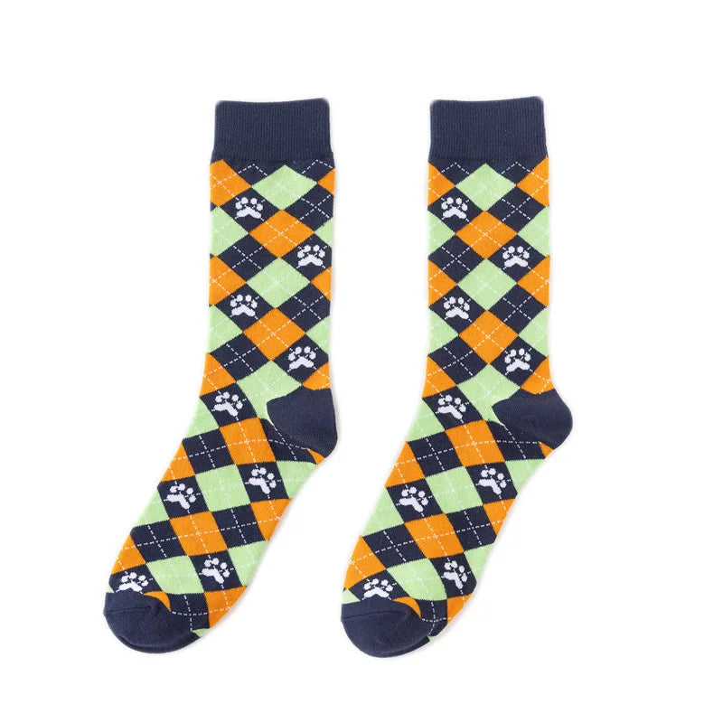 A pair of novelty crew socks featuring a diamond pattern with orange, gray, and black paw prints.