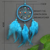 A handmade feather dreamcatcher with a blue hoop and dangling feathers displayed against a gray background.