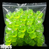 A bag of 10 glow-in-the-dark resin charms shaped like cats and ducks in various shades of lime green.