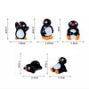A set of cute cartoon penguin resin figurines in black and white with orange accents for fairy garden or Christmas decor.