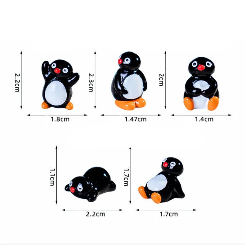 A set of cute cartoon penguin resin figurines in black and white with orange accents for fairy garden or Christmas decor.