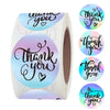Roll of gold foil thank you sealing stickers with handwritten script on a white paper roll