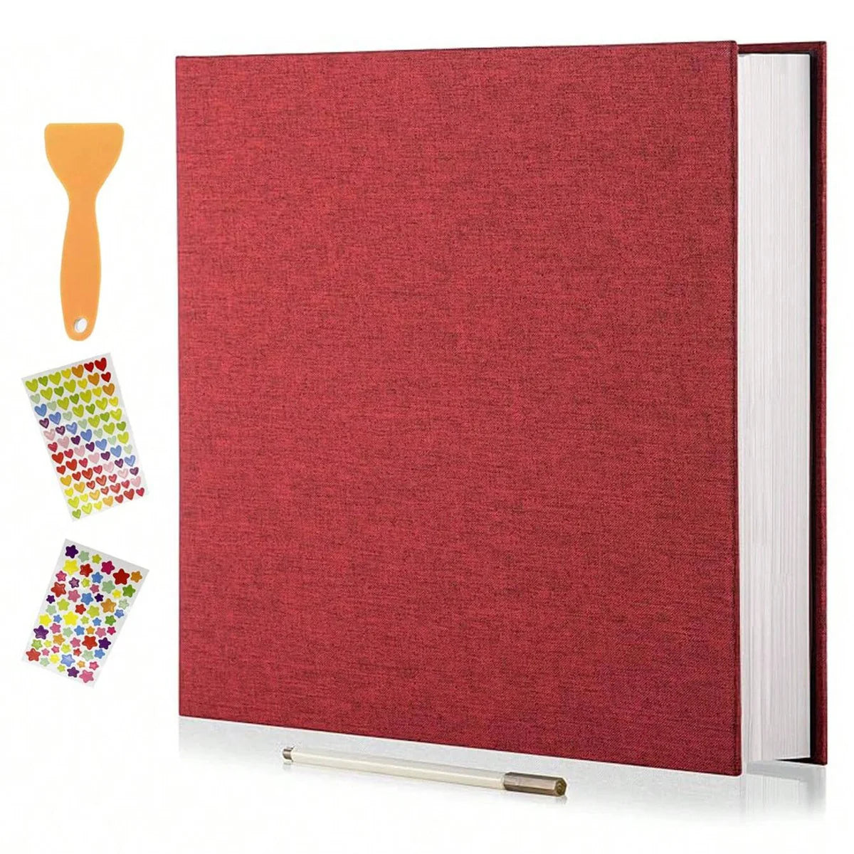 A red linen scrapbook photo album with a visible page and an orange glue stick and adhesive sheets.