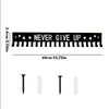 A black wall-mounted metal medal display rack with a 'NEVER GIVE UP' message and various pins.