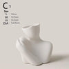 White ceramic figural vase shaped like an artistic human form.