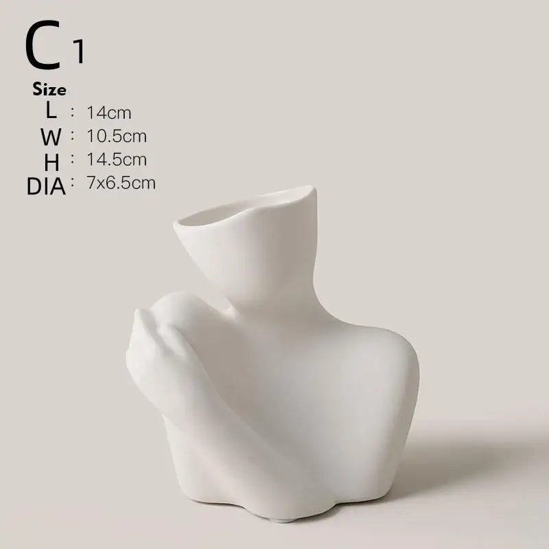 White ceramic figural vase shaped like an artistic human form.