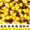 A pile of miniature resin witch hat ducks in yellow and brown colors for crafting and decorating.