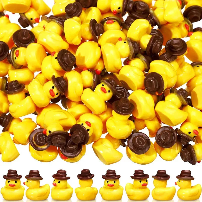 A pile of miniature resin witch hat ducks in yellow and brown colors for crafting and decorating.