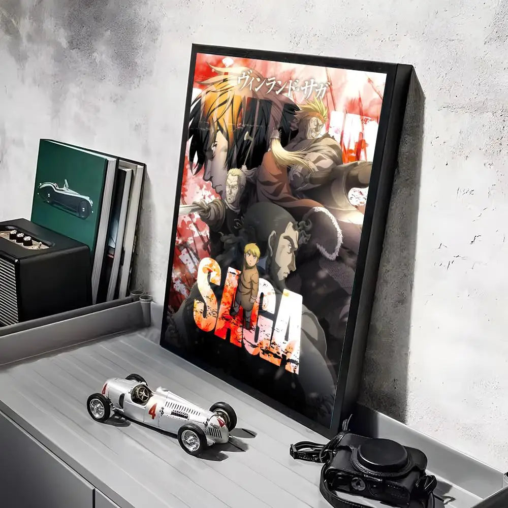 A framed poster of the Vinland Saga anime featuring characters, displayed on a gray shelf.