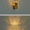 Modern bubble crystal LED wall sconces mounted on a white wall, casting a warm glow.