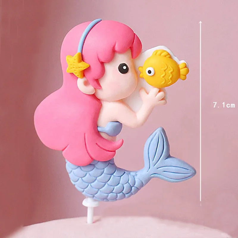A set of ocean animal cake toppers featuring a yellow fish, pink mermaid, and blue turtle on a white background.