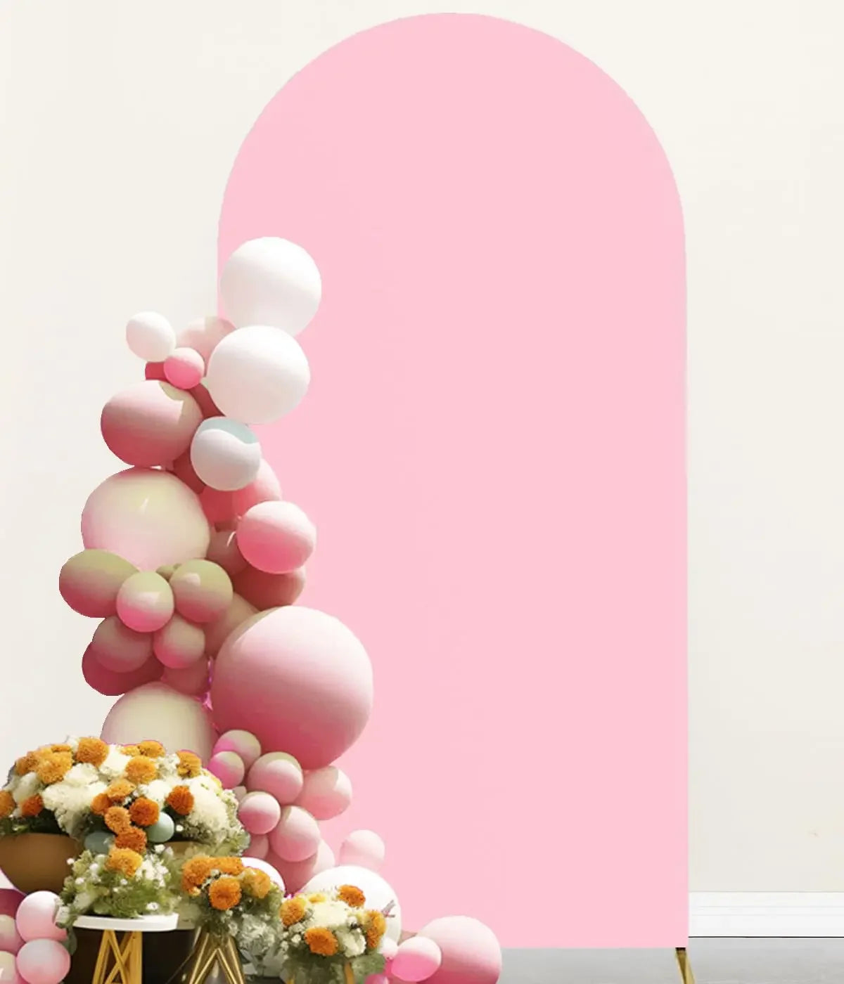 A pink and white balloon floral arrangement against a large pink arch backdrop.