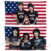 Three individuals posing in front of an American flag backdrop