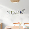 Silver butterfly letter wall mirror decals spelling out HOME on a white wall