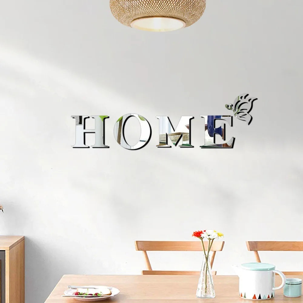 Silver butterfly letter wall mirror decals spelling out HOME on a white wall