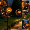 Halloween black cat and pumpkin moon garden stake light illuminating a crescent moon shape in a garden setting