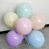 A cluster of matte latex balloons in pastel shades including light blue, pale green, pink, and lavender