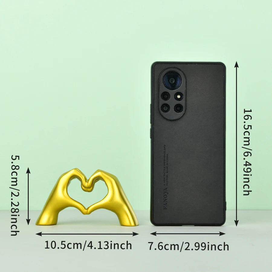 A black smartphone next to a gold heart hand gesture sculpture, showing the product dimensions.