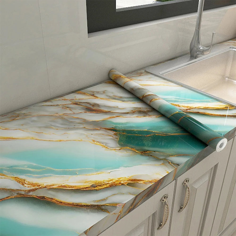 Marble pattern self-adhesive backsplash panel featuring turquoise and gold veining on a kitchen countertop.