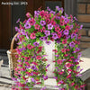A vibrant display of purple and pink faux silk flowers used for outdoor garden decor.