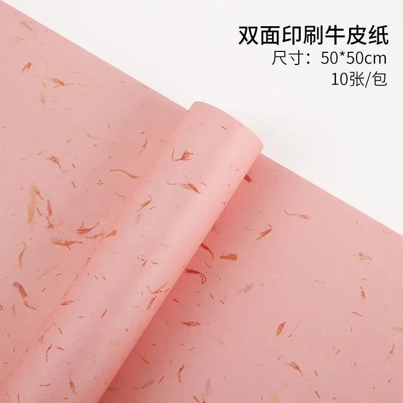 Roll of pink double-printed paper with gold flower petals for decorative packaging