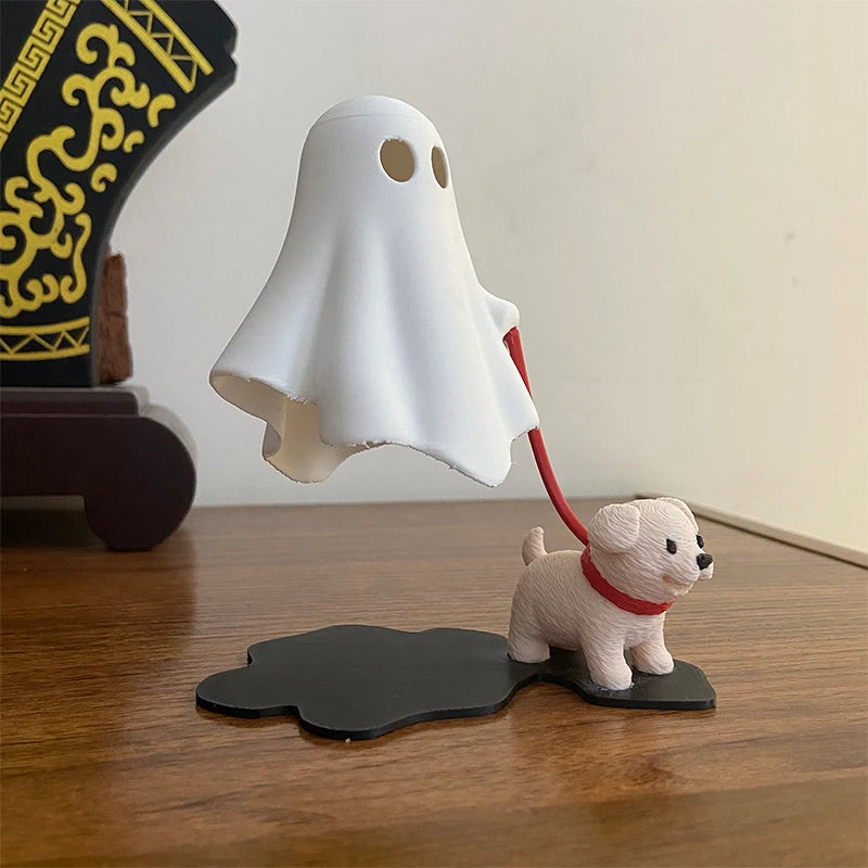 A white ghost figurine is shown hovering above a small dog figurine on a wooden desk.