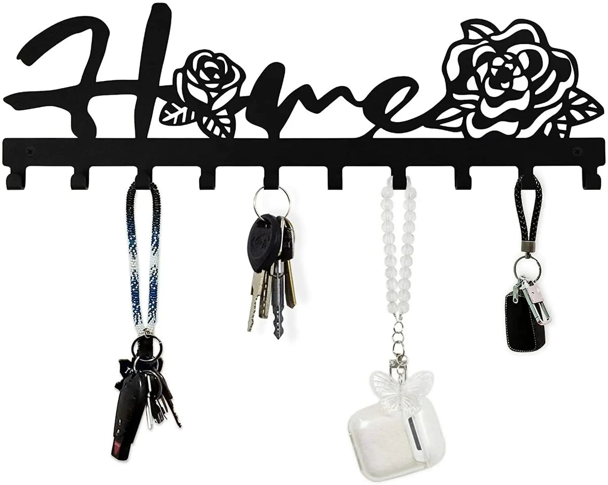 Black decorative metal wall-mounted key holder with seven hooks and various keys hanging from them
