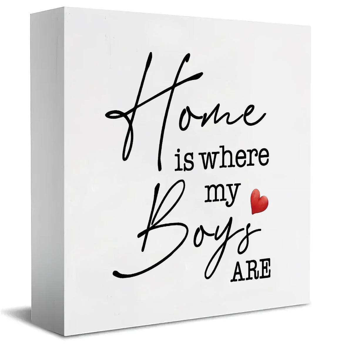 A white rectangular sign with black script that reads Home is where my Boys are and a red heart.