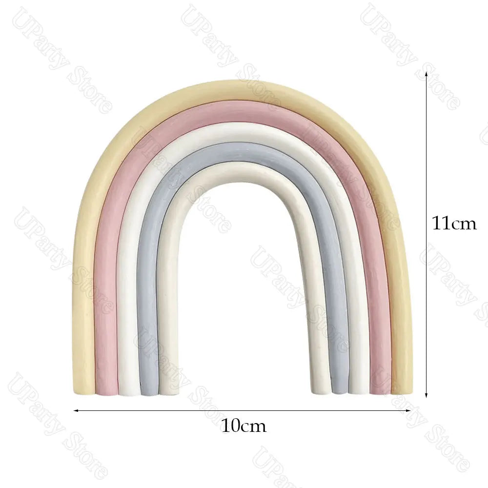 A set of arched rainbow cake toppers featuring multiple pastel colored balls.