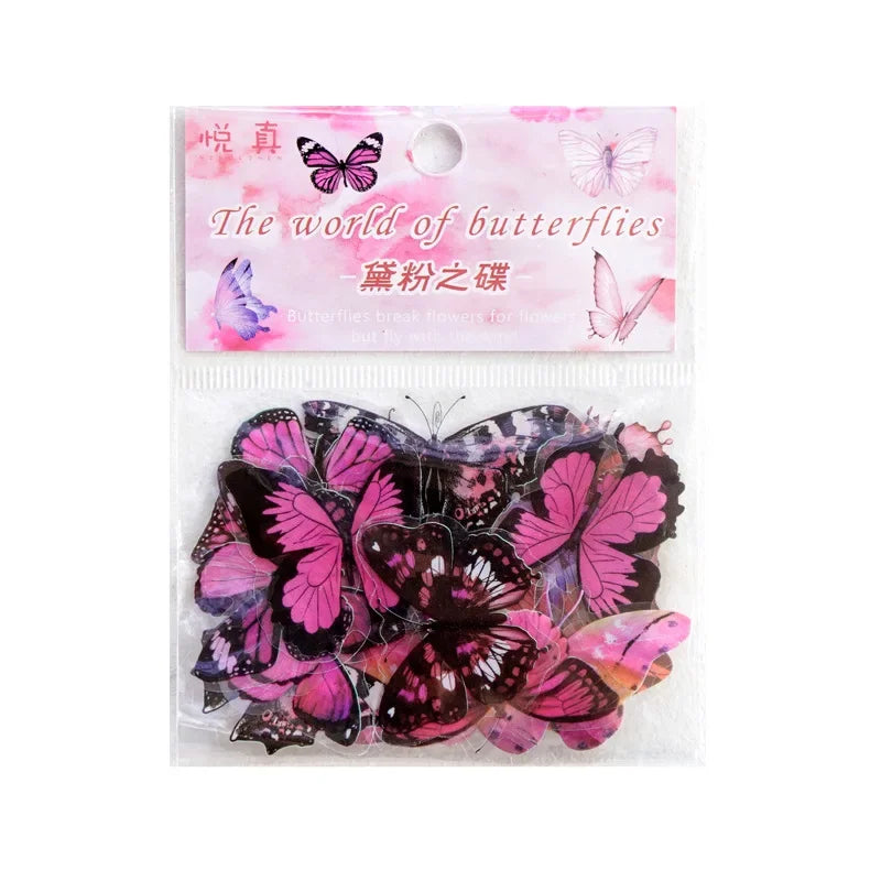 A clear plastic package containing butterfly art collage stickers for scrapbooking featuring various pink and black butterfli