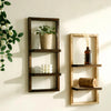 A rustic wooden floating shelf with two tiers displaying a potted plant and a glass bottle.