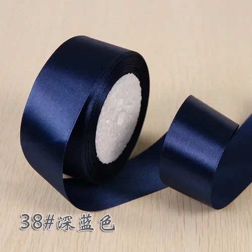 Roll of dark blue silk satin ribbon for gift wrapping and craft projects