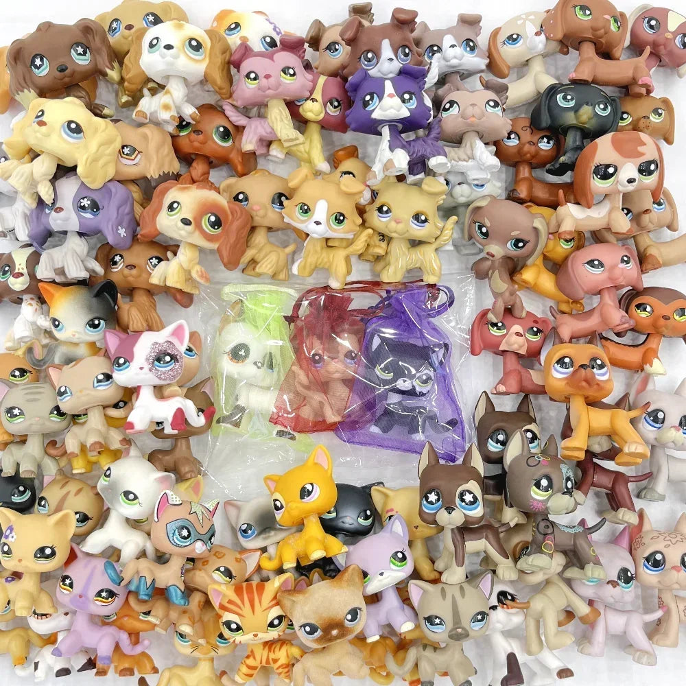 A collection of small bobblehead dog and cat mini figures in various colors and styles.