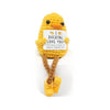 A yellow knitted plush doll shaped like a duck with a tag that reads I DUCKING LOVE YOU