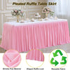 Pink pleated ruffle table skirt displayed on a white table, showing the fabric texture and drape.