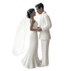 A white wedding cake topper featuring an elegant bride and groom figurine.