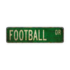 Vintage metal sign with green background and white text reading FOOTBALL DR
