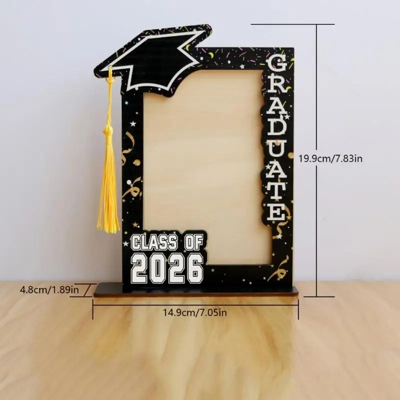 A black graduation photo frame with a gold tassel and the text GRADUATE and CLASS OF 2026