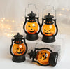 Three orange glowing Halloween LED pumpkin and ghost hanging lanterns displayed on a white surface.